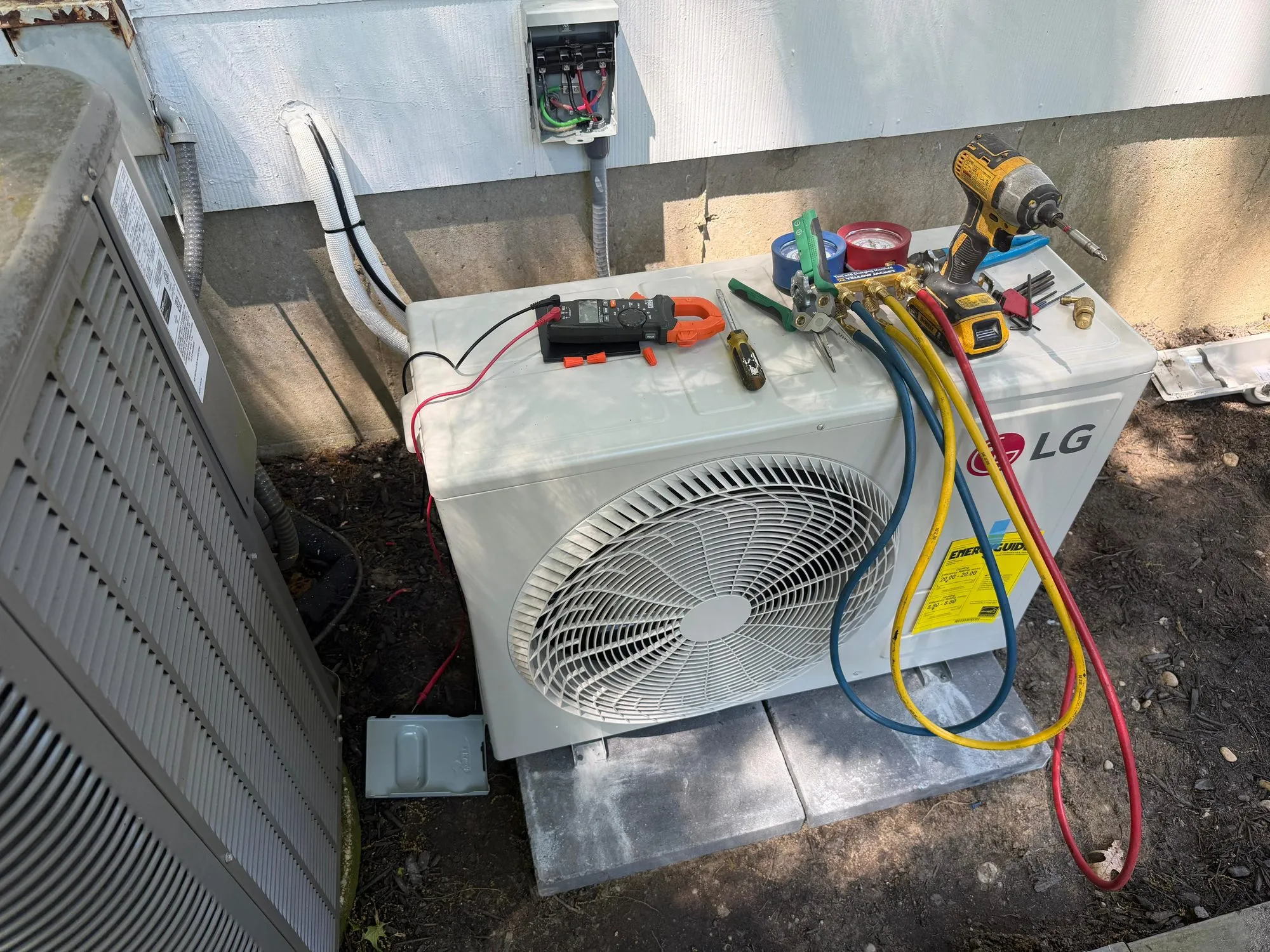 LG ductless mini split outdoor unit connected to refrigerant gauges during service