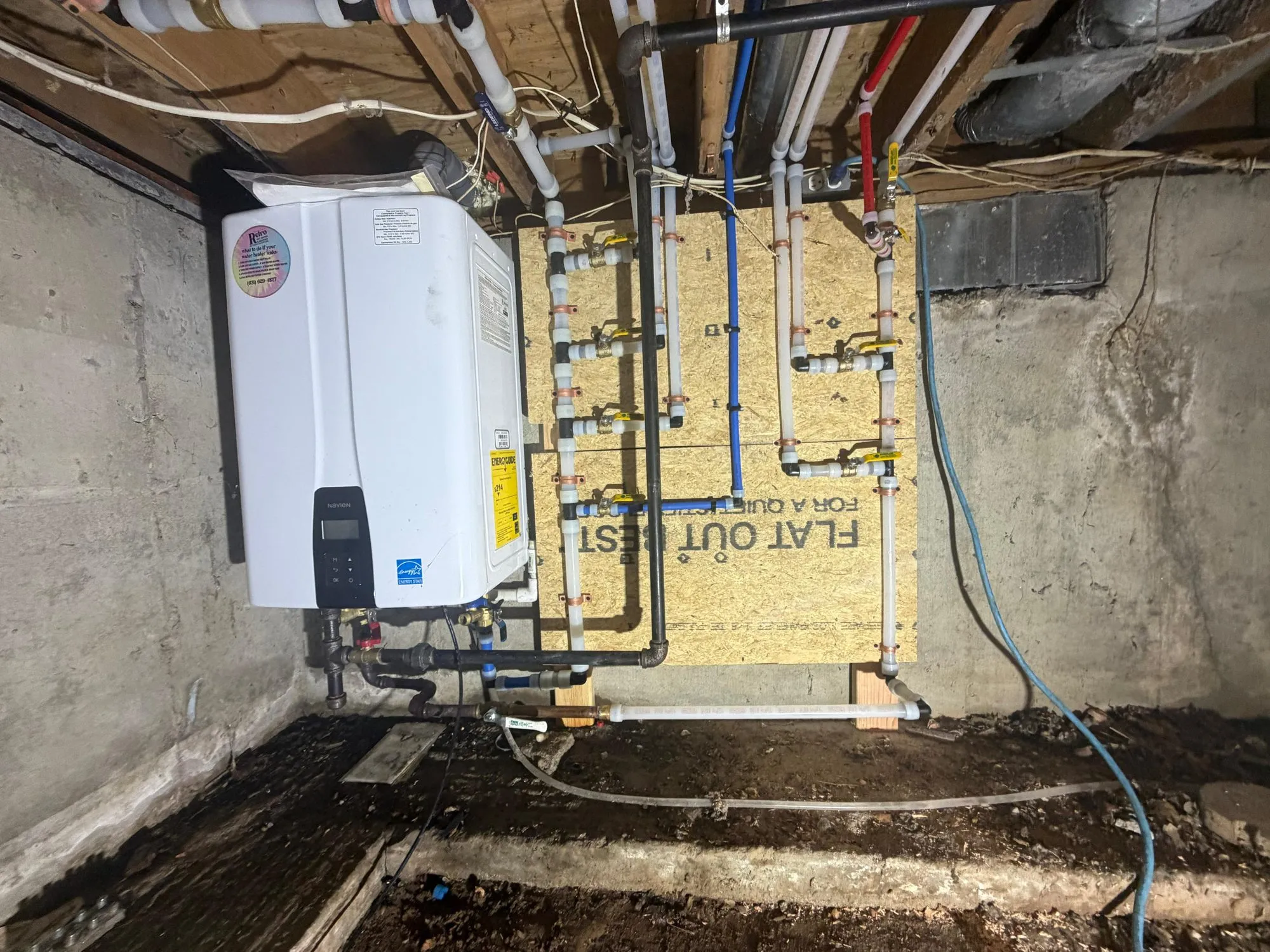 Navien tankless water heater with PEX home-run distribution manifolds in a crawlspace